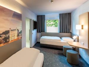 Postel nebo postele na pokoji v ubytování B&B HOTEL Magdeburg-Barleben