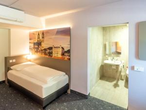 Postel nebo postele na pokoji v ubytování B&B HOTEL Magdeburg-Barleben