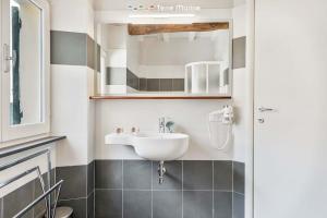 a bathroom with a sink and a mirror at Lover's Lane 2, TerreMarine in Riomaggiore +3 photos