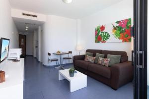 a living room with a couch and a table at Beachfront Apartment Playa del Cura 3 by VillaGranCanaria in Playa del Cura +33 photos