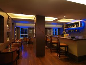 a bar in a restaurant with tables and chairs at Goldfinch Retreat Bangalore in Devanahalli-Bangalore