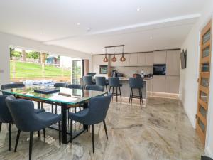 a kitchen and dining room with a table and chairs at The Bay in Benllech