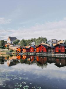 a group of houses next to a body of water at RUNO Hotel Porvoo in Porvoo