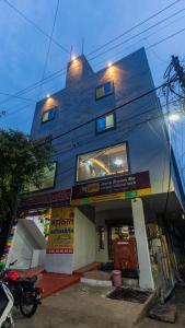 a blue building with a motorcycle parked in front of it at Hotel Mahakal Avantika Palace in Ujjain