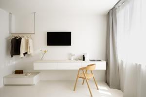 a white room with a desk and a chair at Hotel Hello Plovdiv - Free Parking and Pet Friendly in Plovdiv