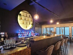 a restaurant with a bar with chairs and a mirror at reiminski Abenteuer Space Kapseln, Tennis Squash Soccer, Sport & Wellness in Bergen