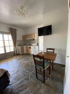 a living room with a table and a kitchen at Studio Villa Emeli, close to beaches and downtown in Porto Heli