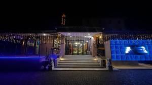 a building decorated with christmas lights at night at Hotel Ristorante Oro in Cento