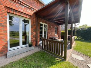 a porch of a brick house with a patio at A12 Das rote Haus am Haff Roggow Ostseebad Rerik in Roggow
