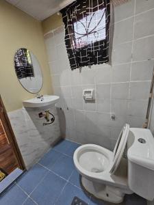 a bathroom with a toilet and a sink at The Catolico's 2 bedroom Transient in Baguio