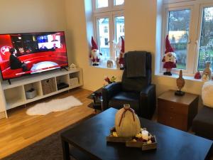 a living room with a santa hats on the tv at Engen 6 in Bergen