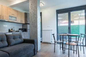 a living room with a couch and a table with chairs at Apartmani Putnik in Vrnjačka Banja