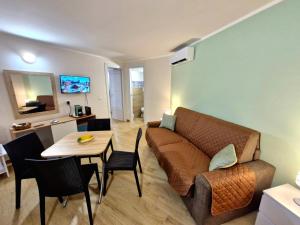 a living room with a couch and a table at Medea in Syracuse