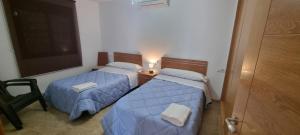 two beds in a small room with a chalkboard at Casas Rurales Racha Rachel, Zarza la Mayor in Zarza la Mayor
