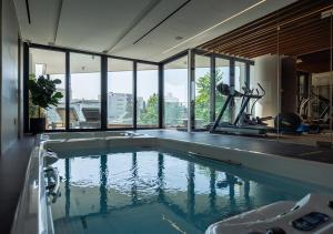 a large swimming pool in a room with windows at Nicosia Central Park Residences in Nicosia