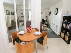 a dining room with a wooden table and chairs at Grassholm View in Haverfordwest