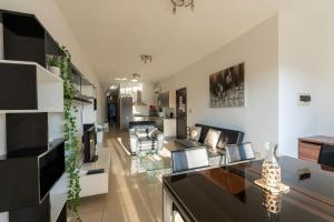 a living room with a couch and a table at Cozy Bedroom, shared bathroom -Gzira in Il-Gżira