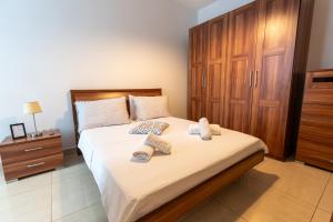 a bedroom with a bed with two towels on it at Cozy Bedroom, shared bathroom -Gzira in Il-Gżira