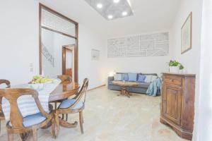 a living room with a table and a couch at SUITE Le Barche in Mestre +21 photos