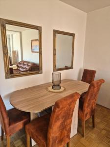 a dining room table with chairs and a mirror at N-Condo in Sarajevo in Sarajevo