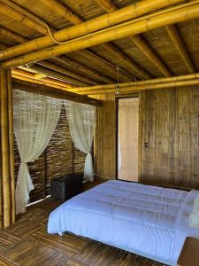 a bedroom with a large bed in a wooden room at Casa campestre madremonte in Villeta