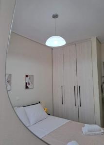 a bedroom with a bed and a mirror at Villa THEASIS Panoramic in Kastanéa