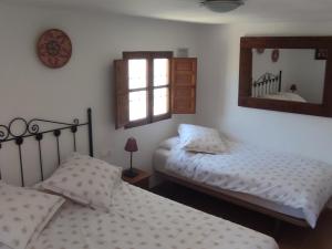 Postel nebo postele na pokoji v ubytování B&B Cortijo Loma León