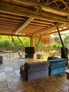 a living room with two couches and a swing at Casa campestre madremonte in Villeta +13 photos