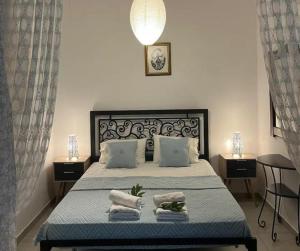 a bedroom with a large bed with towels on it at Aurora Studio Lagonissi in Lagonissi