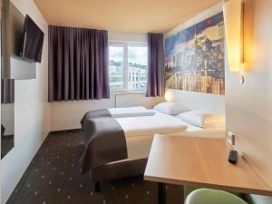 Postel nebo postele na pokoji v ubytování B&B HOTEL Frankfurt City-Ost