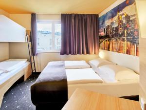 Postel nebo postele na pokoji v ubytování B&B HOTEL Frankfurt City-Ost