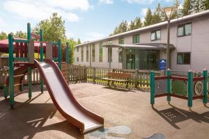 a playground with a slide in front of a building at Days Inn Winchester in Winchester