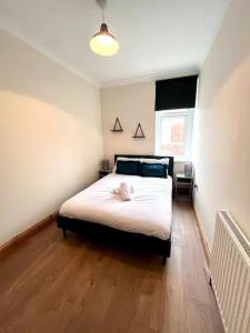 a bedroom with a large white bed in it at Enjoy A Spacious 3 Br Home in Gateshead