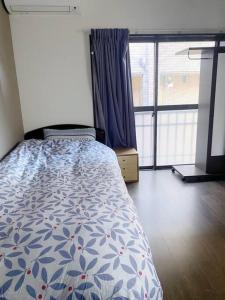 Postel nebo postele na pokoji v ubytování 小岩民泊宿