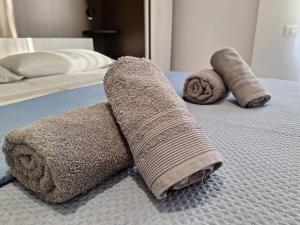 two towels sitting on top of a bed at BeB Tatiana in San Donato Milanese +3 photos