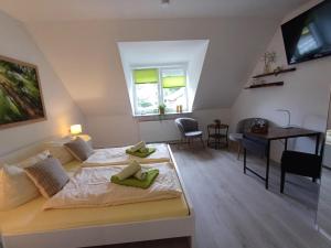 a bedroom with a bed and a desk in it at Landhaus Tewel Hotel mit Restaurant 14KM vom Heide-Park in Tewel