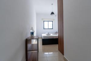 a bedroom with a bed and a table with a mirror at Brightest Room, Shared Bathroom Gzira in Il-Gżira