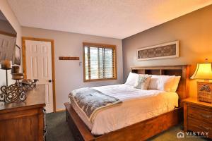 a bedroom with a bed and a desk and a window at Giant steps 13 - Ski In Ski Out in Brian Head +22 photos
