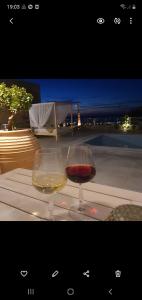 a glass of wine sitting on top of a table at Villa petros in Malia