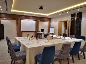 a conference room with a large table and chairs at Reef Home Hotel in Riyadh