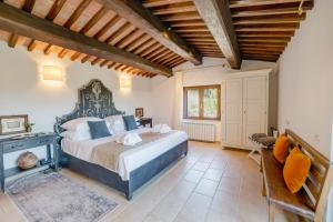 a bedroom with a large bed and a fireplace at Villa Destino Italy, Umbria Tuscany boarder in Montone +86 photos