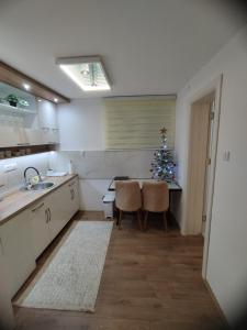 a kitchen with a christmas tree and a table and chairs at Sweet Dreams in Gornji Milanovac