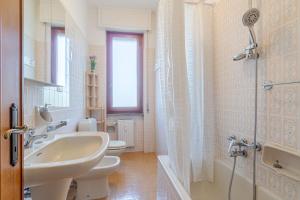 a bathroom with two toilets and a sink and a shower at Mare e Monti a due Passi dalla Spiaggia! Ligurian Vacation Apartment in Chiavari +12 photos