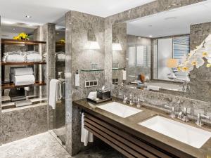 a bathroom with two sinks and a large mirror at Mandarin Oriental, Jakarta in Jakarta
