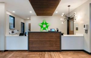 an office with a reception desk with a green star on the wall at Extended Stay America Premier Suites - Belgrade - Bozeman - Yellowstone Airport in Belgrade