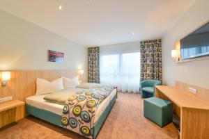 Postel nebo postele na pokoji v ubytování Ammi Hotel Garni