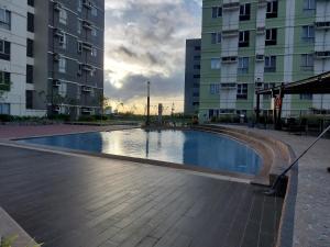 a swimming pool in front of some tall buildings at Cozy Apartment in Cebu IT Park T2517 in Cebu City