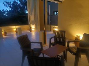 a patio with chairs and a table and lights at La Shashalia Luxury in Pondicherry
