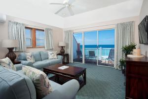 a living room with a couch and a table at Pompano Beach Club in Southampton