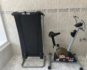 a treadmill and an exercise bike in a bathroom at Sweet Home in Miranda do Douro